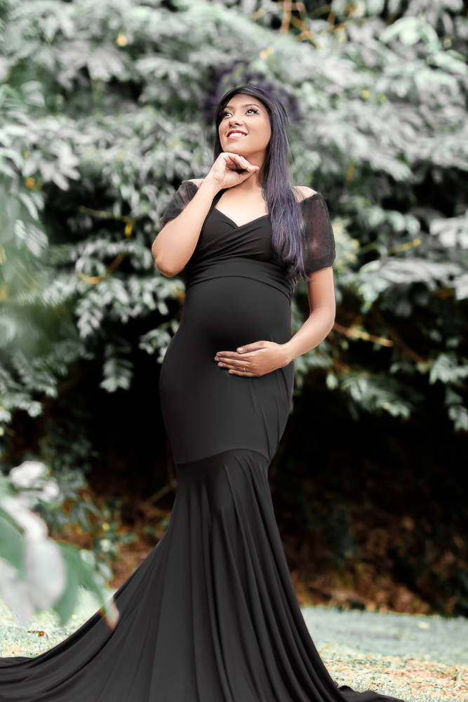 Frau mit Babybauch im schwarzen Babybauch-Shootingkleid