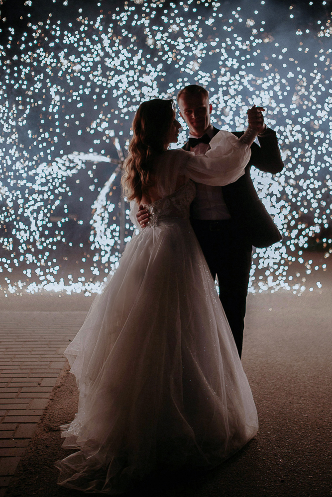 Hochzeit mit Feuerwerk, das Brautpaar tanzt in Wolfsburgwährend des Brautpaar-Shootings davor.